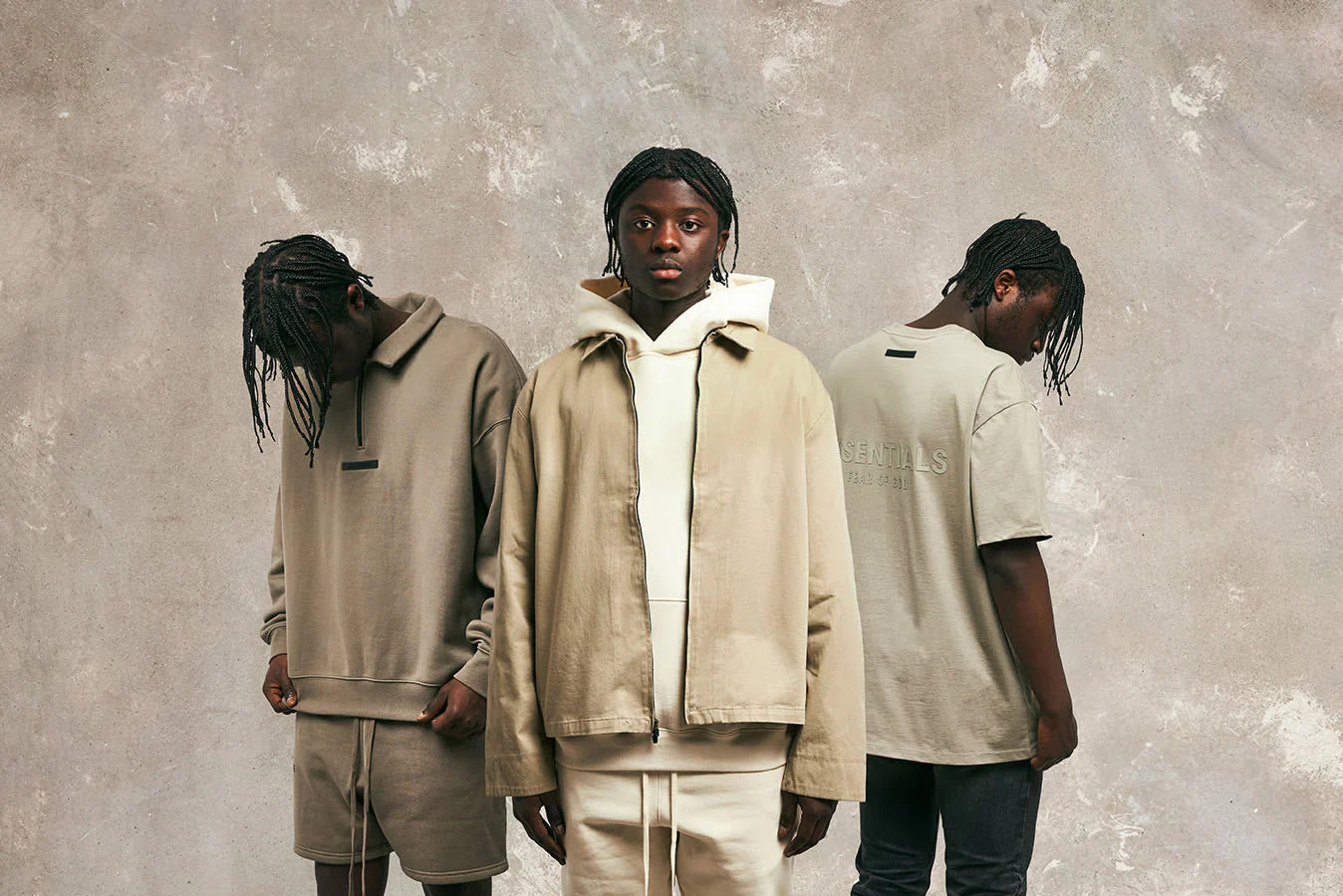 Three models showcasing Fear of God Essentials clothing, featuring modern casual styles in neutral colors.