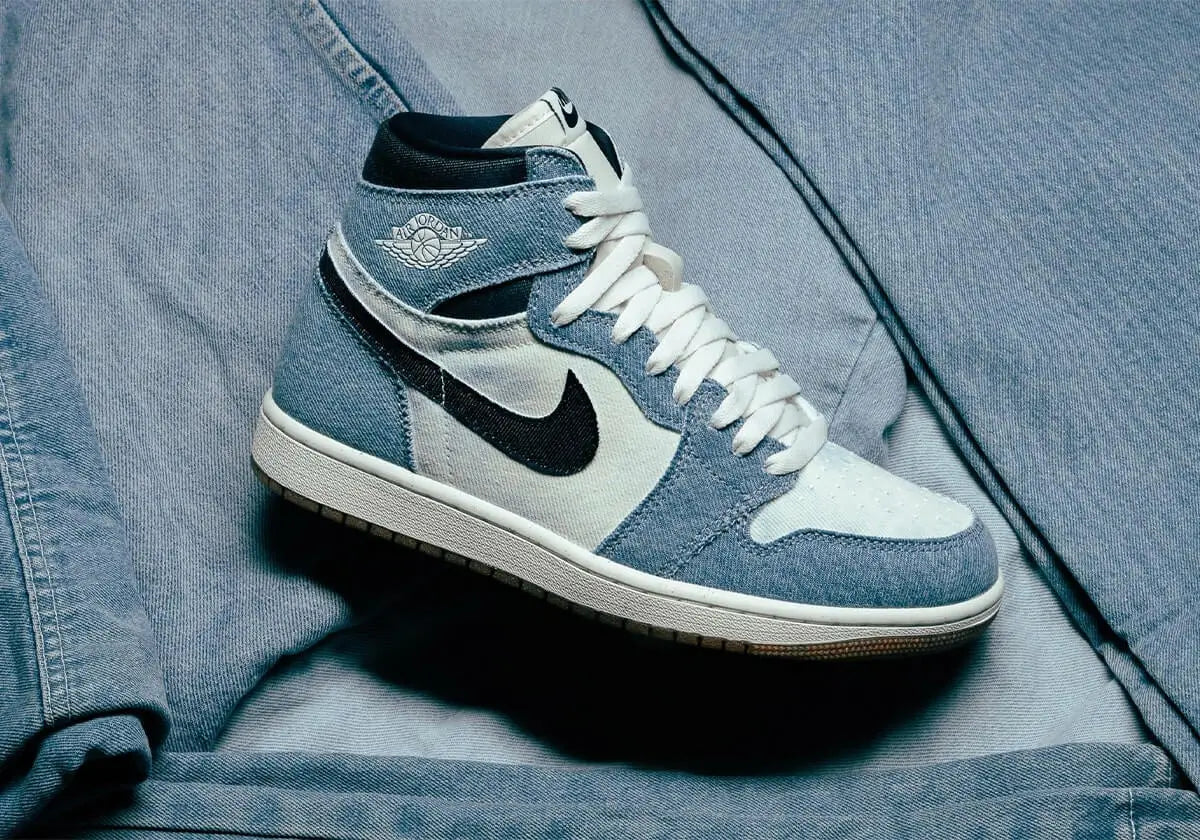 Air Jordan 1 sneakers in blue denim style on a denim background, showcasing iconic design and sneaker culture.