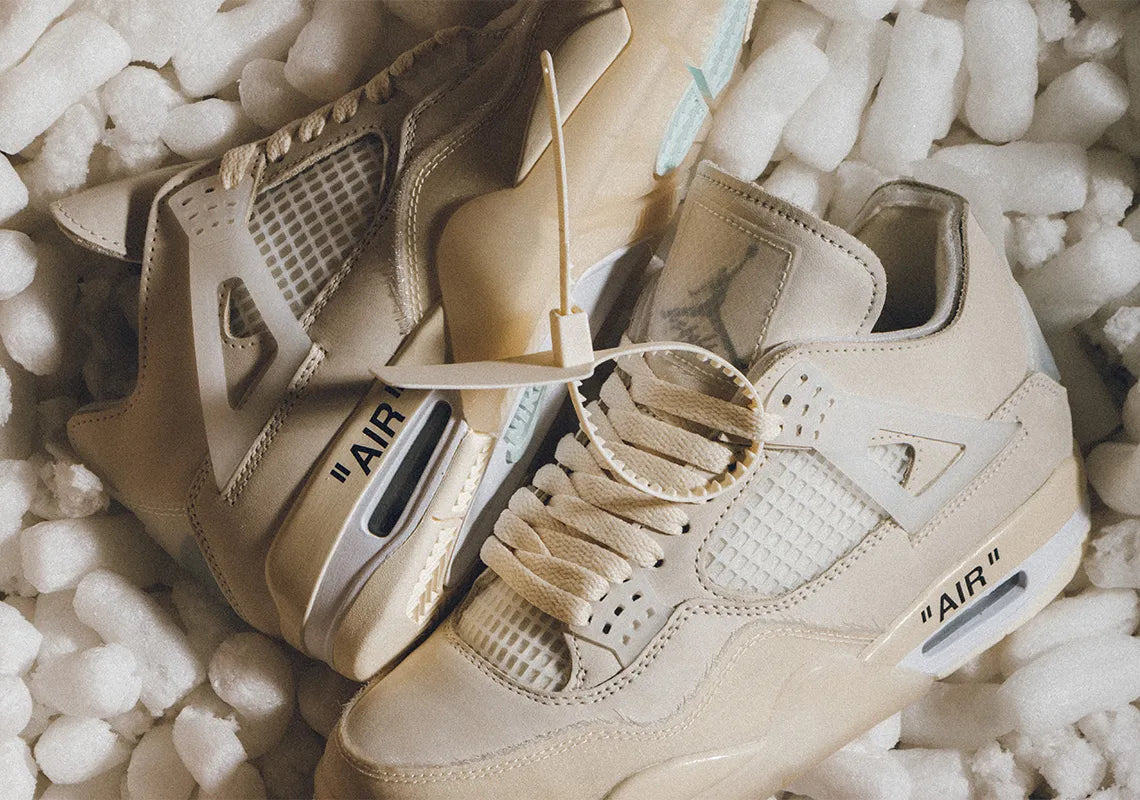 Close-up of trendy beige sneakers on packing foam, showcasing unique design and 'AIR' branding, perfect for sneaker predictions.