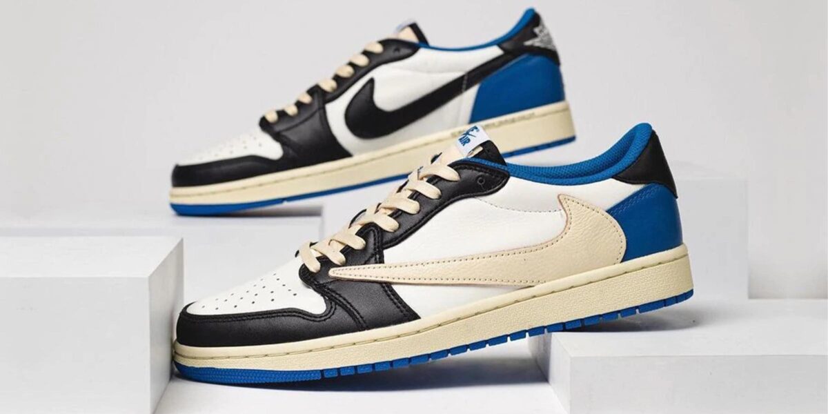 Travis Scott sneaker design featuring black, white, and blue color scheme with signature Nike logo.