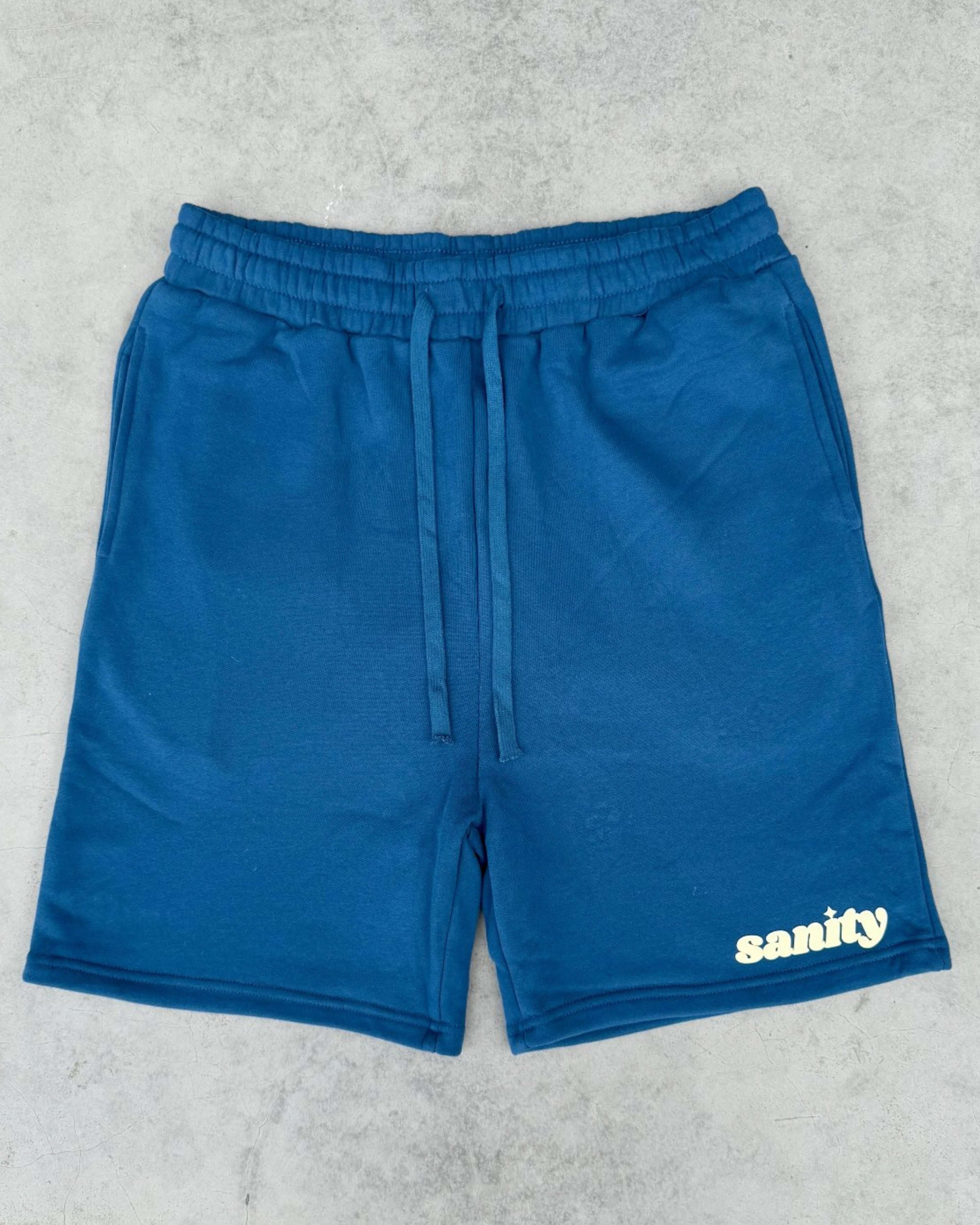 Sanity Deep Sea Men's Shorts in deep navy color with an elastic waistband and drawcord, perfect for comfort and style.