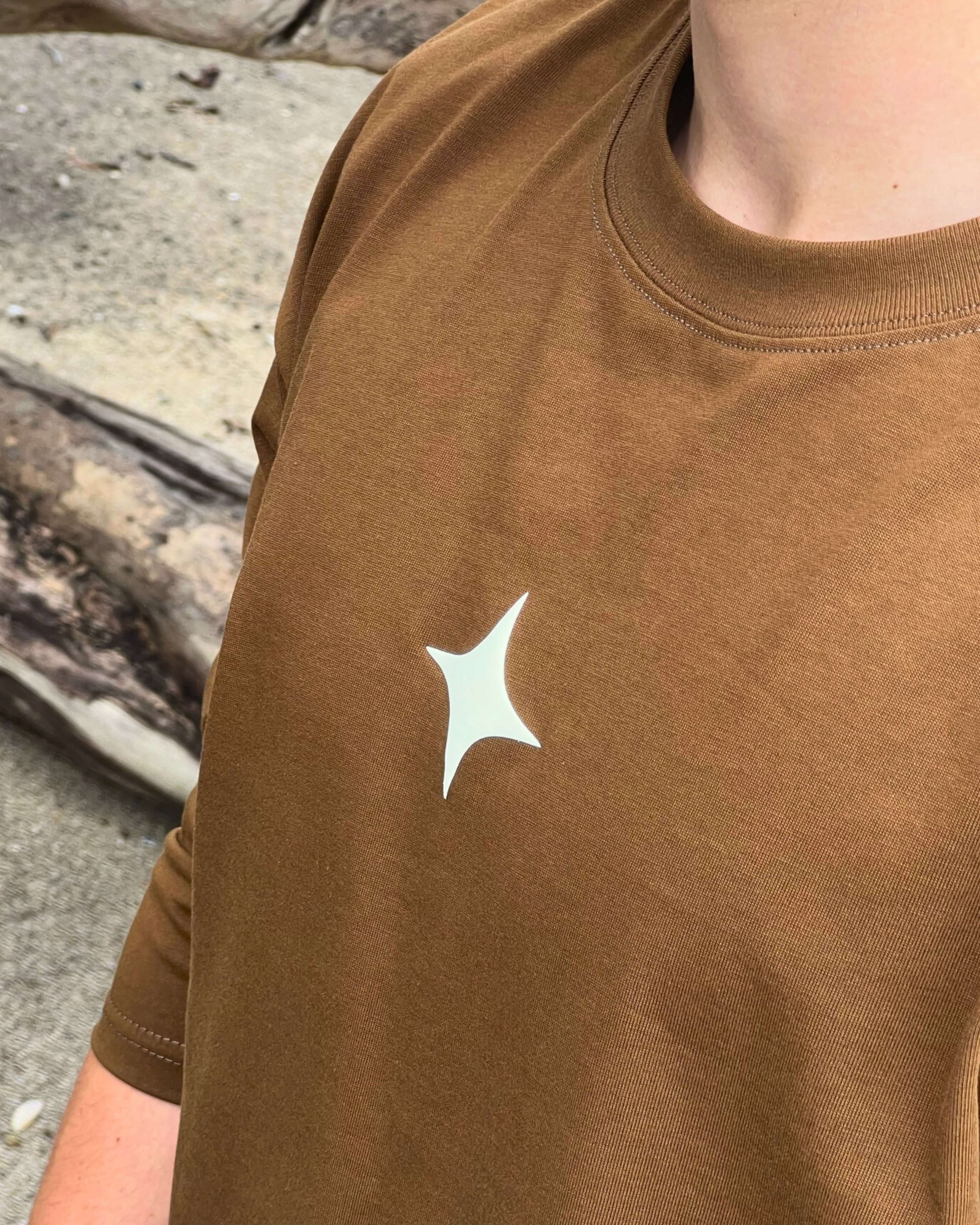 Close-up of a mocha long sleeve tee featuring a unique star design on the chest, ideal for casual wear.