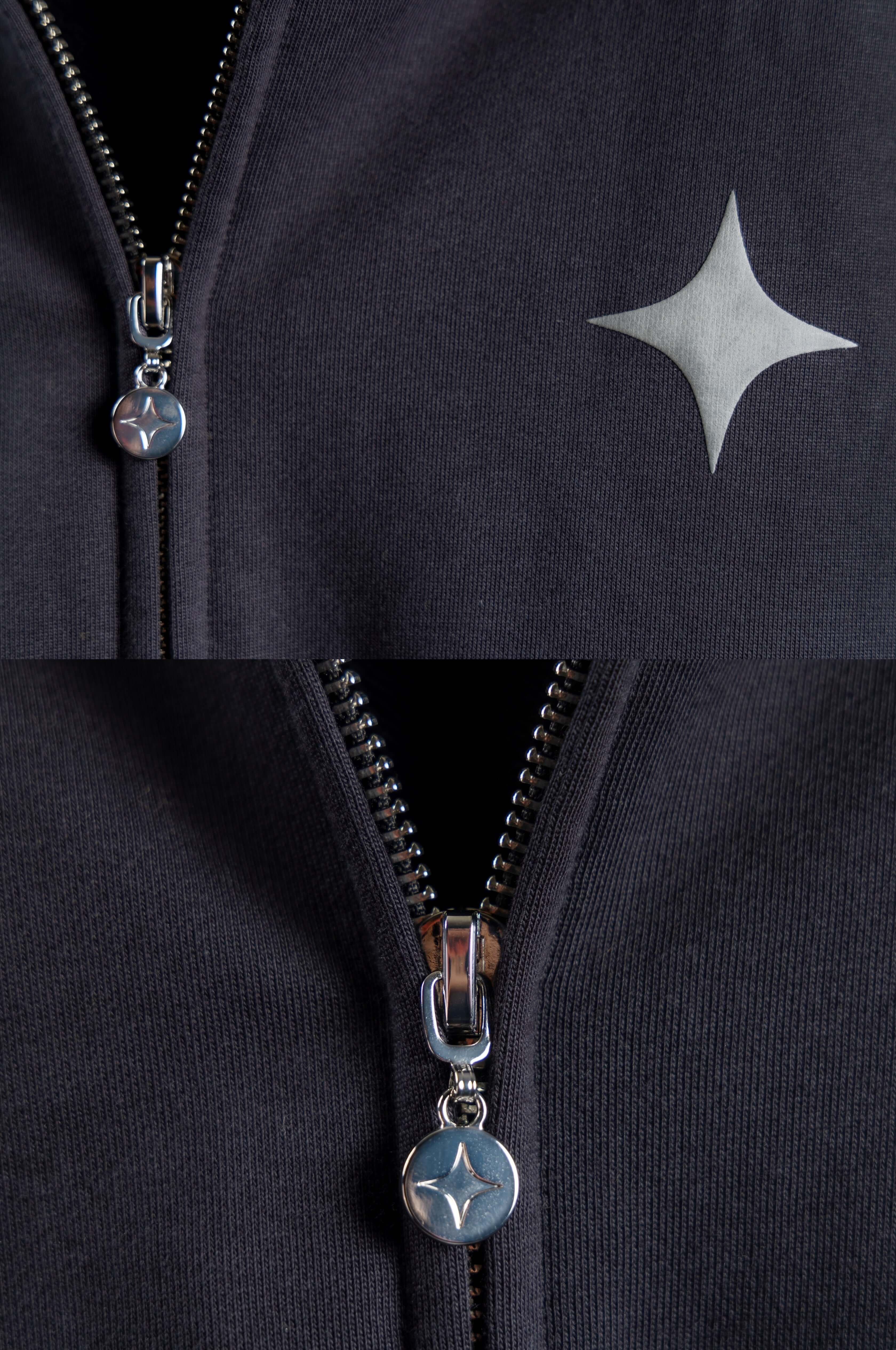 Close-up of the Sanity Midnight Zip-Up hoodie showcasing the grey puff print and silver zipper detail.