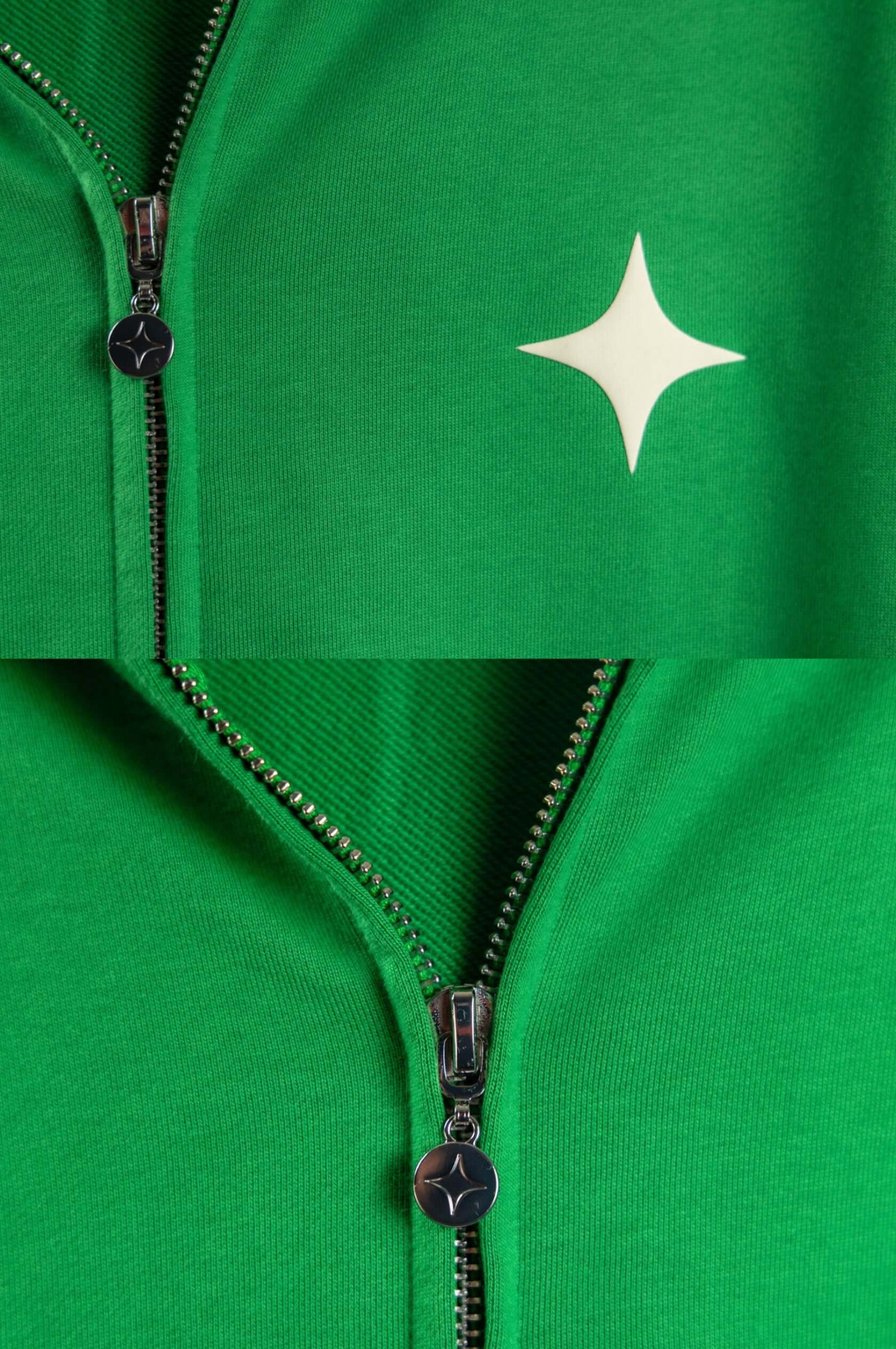 Close-up of the green zip-up hoodie showcasing a star logo and zipper details.