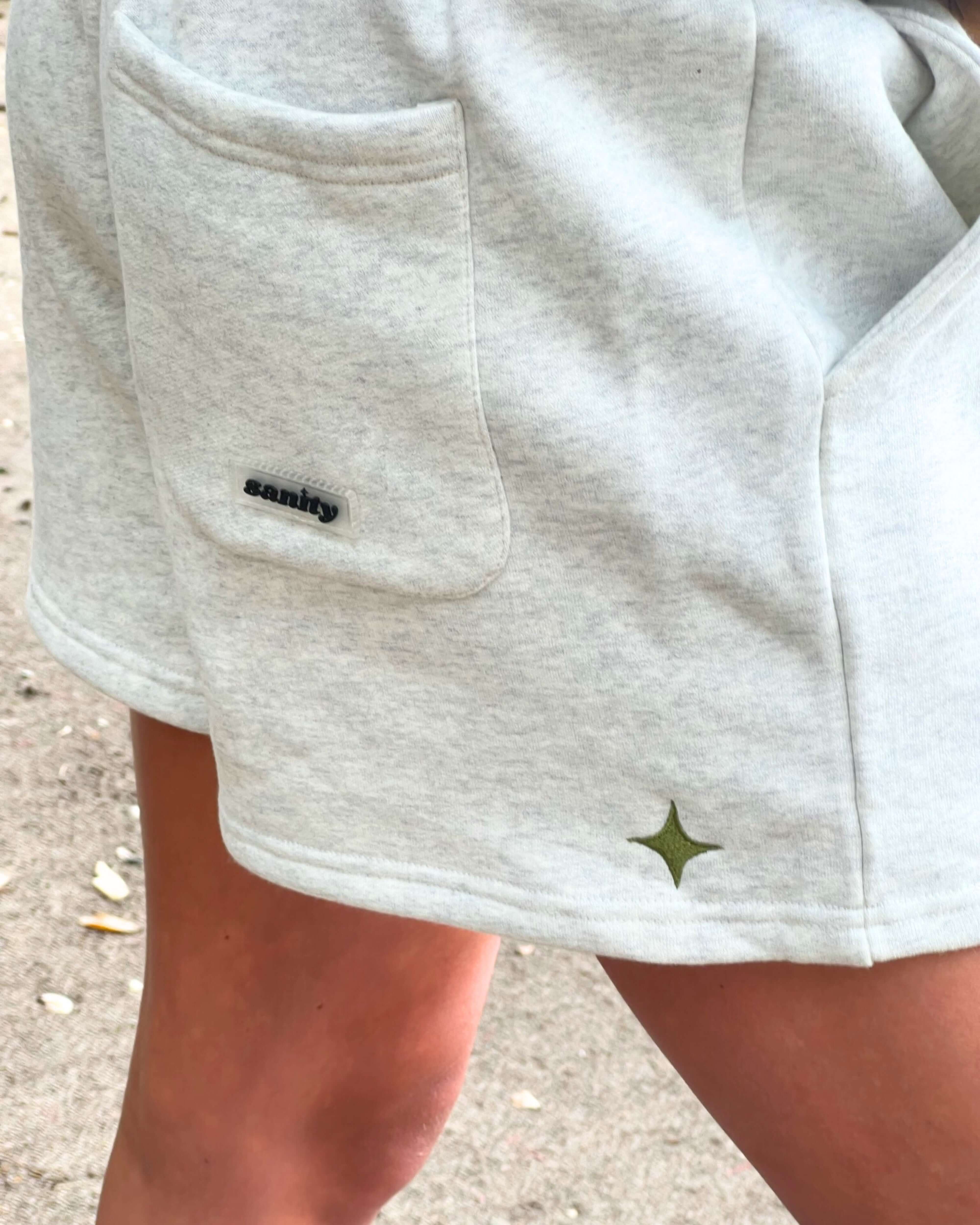 Close-up of Sanity women's shorts featuring side pockets and logo detail, perfect for stylish summer looks.