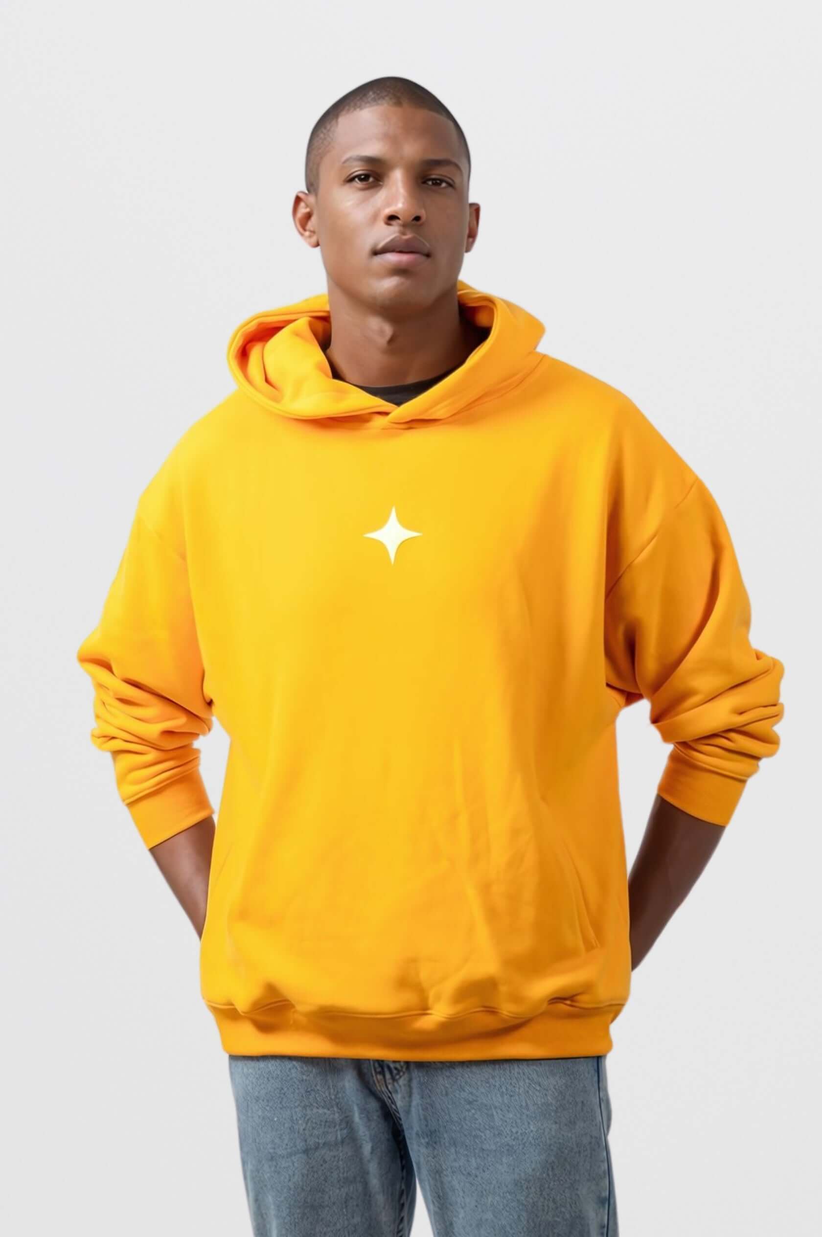 Model wearing a bright yellow hoodie with a white star design, showcasing a casual and stylish look.