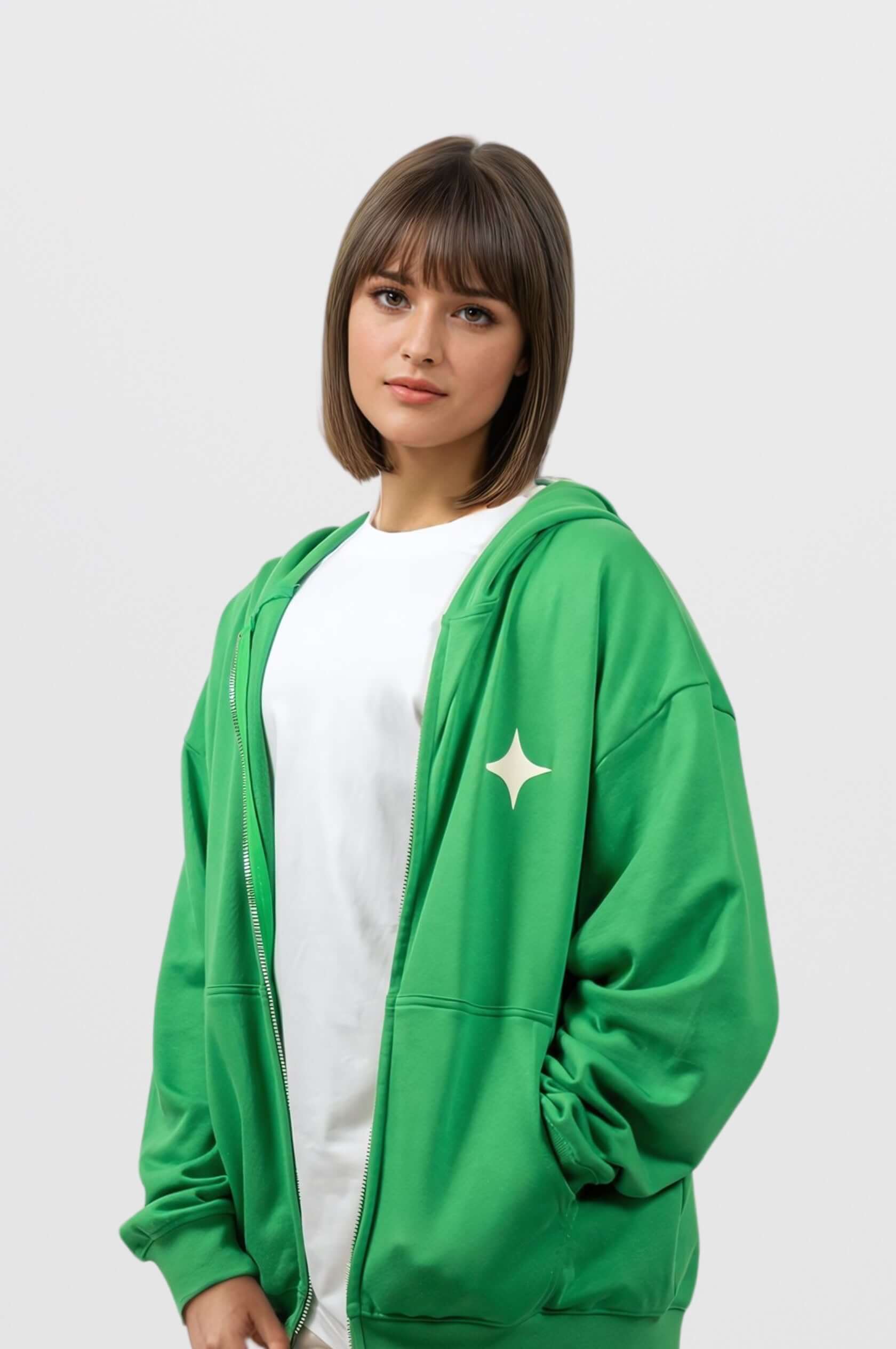 Model wearing a green zip-up hoodie with white print, showcasing a trendy and relaxed look.