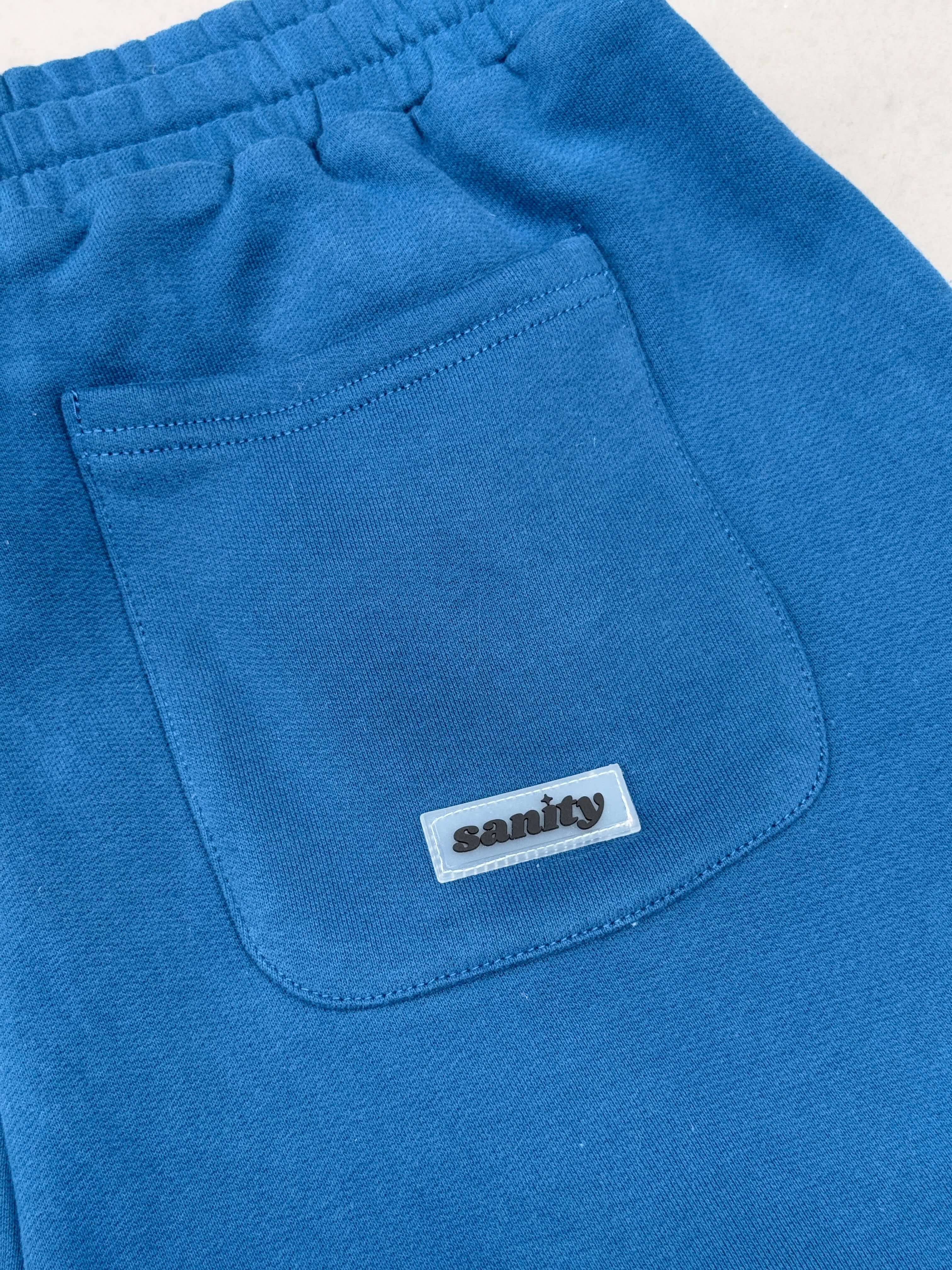 Close-up of Sanity Deep Sea Shorts pocket in vibrant blue, showcasing durable fabric and stylish design details.