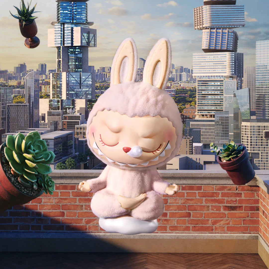 Pop Mart Labubu lazy yoga figure in a pink bunny outfit, set against a city skyline with plants.