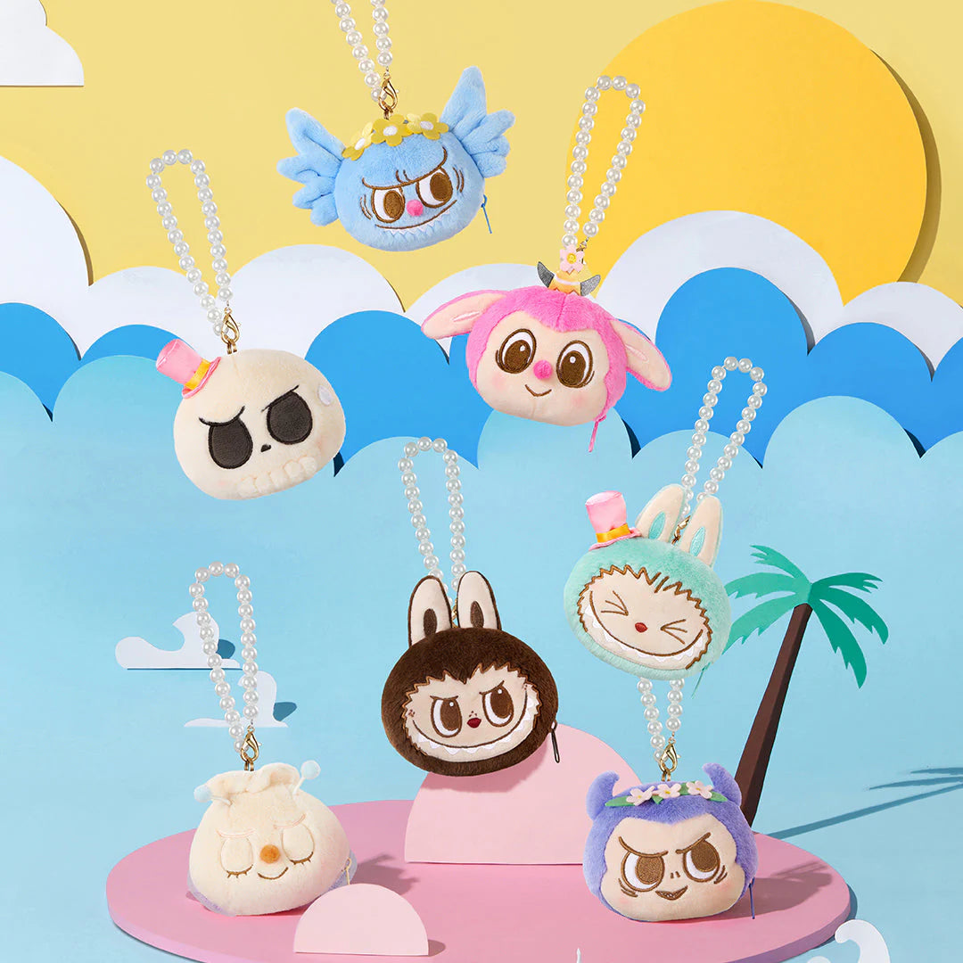 Colorful plush keychains from Pop Mart featuring unique characters in a sunny playful setting.