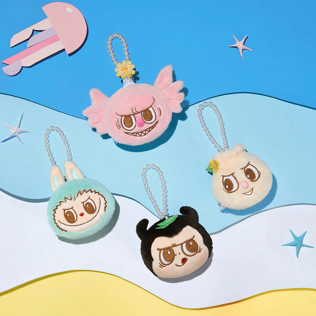 Colorful plush keychains featuring cute character designs against a blue and yellow background.