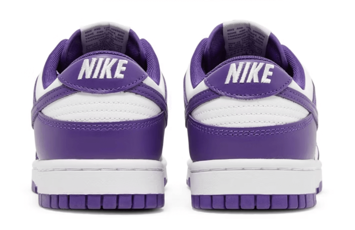Nike Dunk Low Court Purple sneakers featuring a white and purple colorway, showcasing the heel and Nike logo.