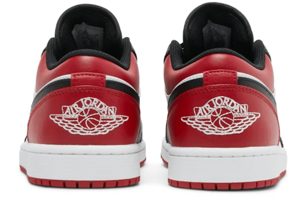 Back view of Jordan 1 Low Bred Toe (GS) sneakers featuring red and black accents, 100% authentic and brand new.