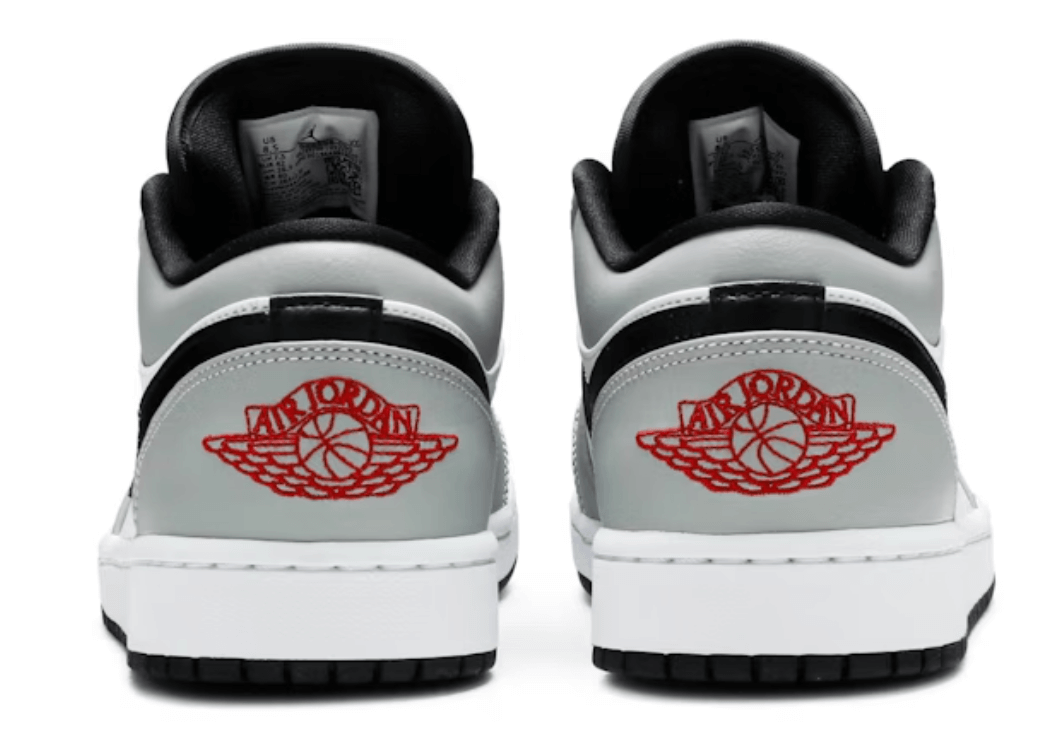 Back view of Jordan 1 Low Light Smoke Grey sneakers featuring red Air Jordan logo on heel. 100% authentic, brand new.