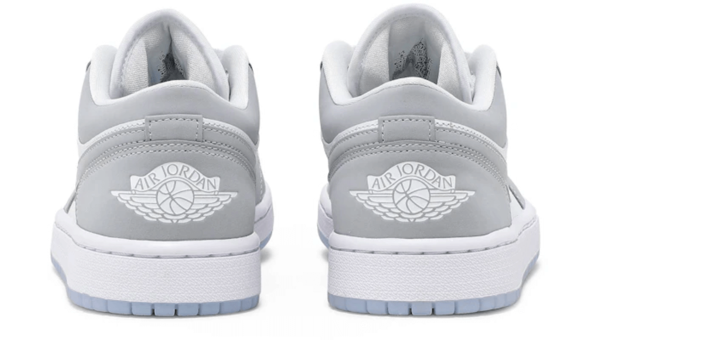 Back view of women's Jordan 1 Low Wolf Grey sneakers, featuring a sleek grey design and iconic Air Jordan logo on the heel.