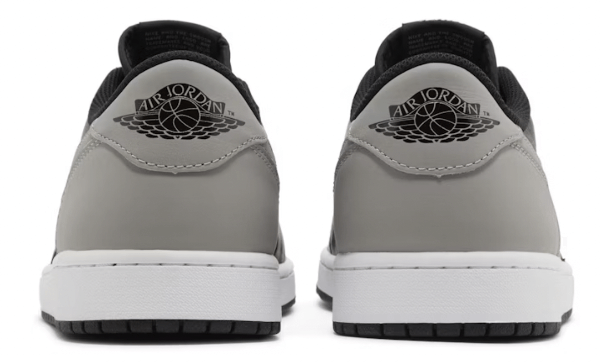 Back view of Jordan 1 Retro Low OG Shadow sneakers featuring iconic Air Jordan logo and sleek gray design.