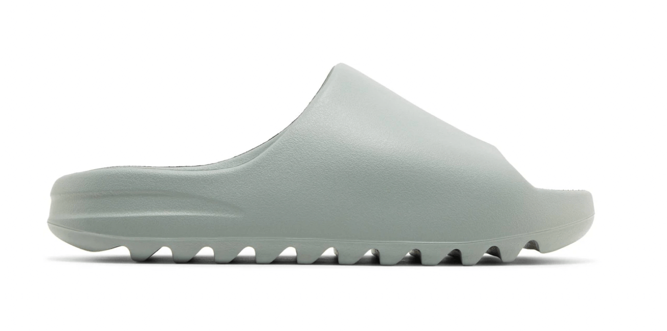 adidas Yeezy Slide Salt in light gray color, featuring a sleek design and textured sole, perfect for casual wear.