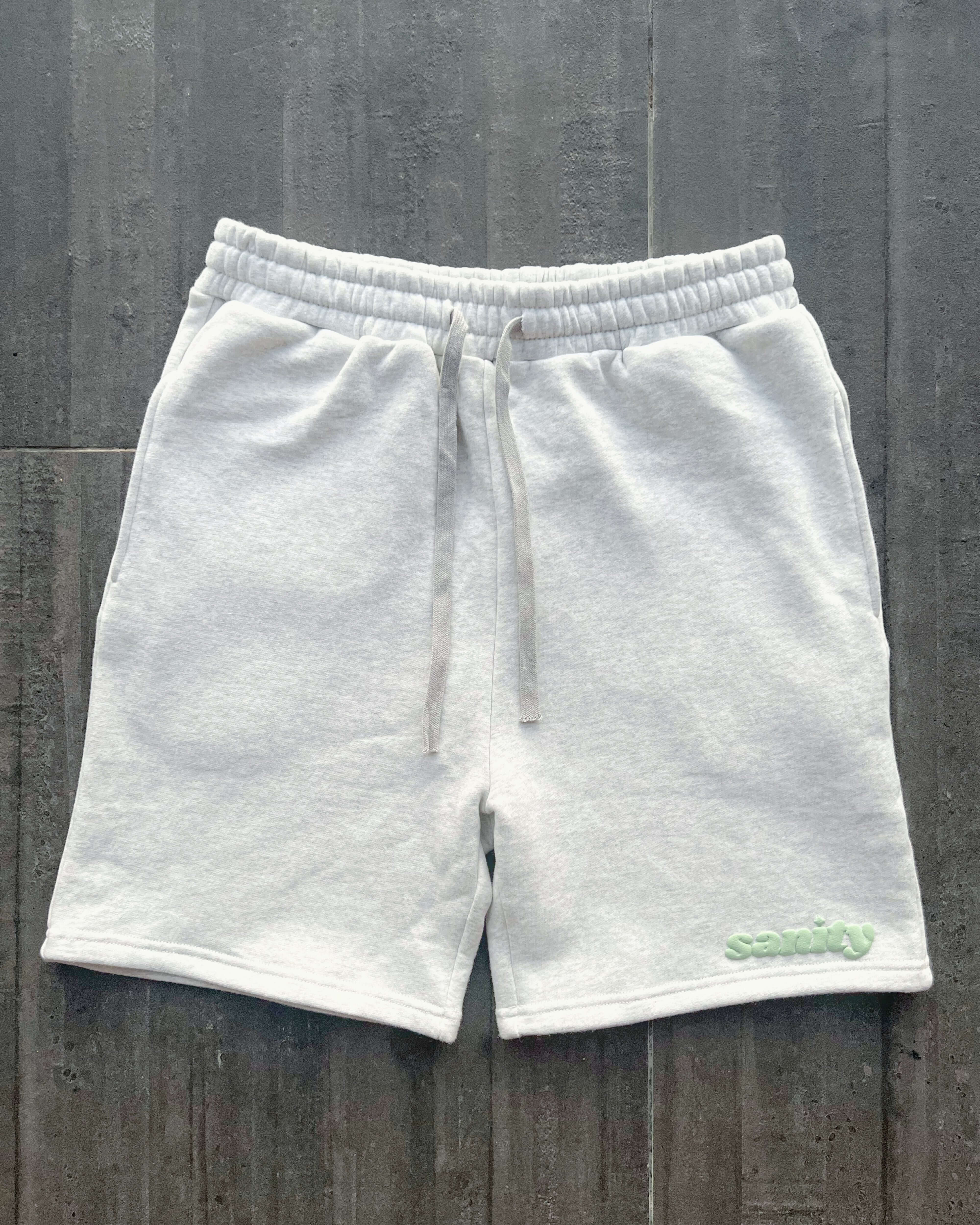 Sanity Snow Men's Shorts in light gray, featuring drawcord and side pockets for comfort and style.