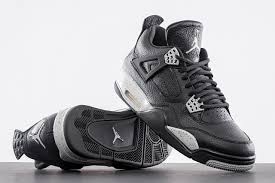 Air Jordan 4 sneakers in black and silver, showcasing iconic design and style.